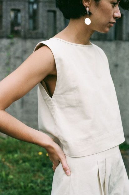 Photo of a woman wearing a simple and elegant white cotton top.