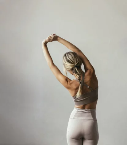 Photo of a woman stretching in preparation for fitness courses.